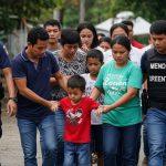 Authorities escorting minors to safety in Davao Oriental, Philippines.